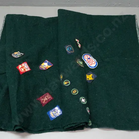 green woollen blanket with Onehunga label and numerous Girl Guides and other badges & NZ souvenir pennants - wear and a