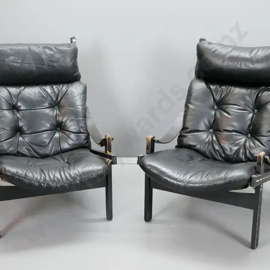 pair of retro timber and black leather slung back lounge chairs with canvas seat and back strung through frame, leather