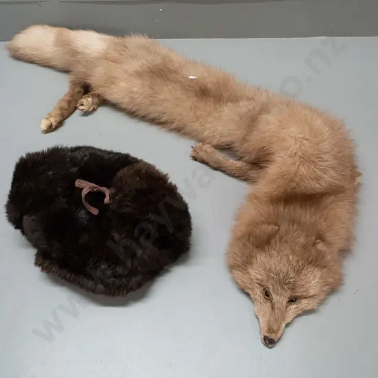 light brown fox fur stole L-1200 and a brown fur hat with tie-up ear flaps.