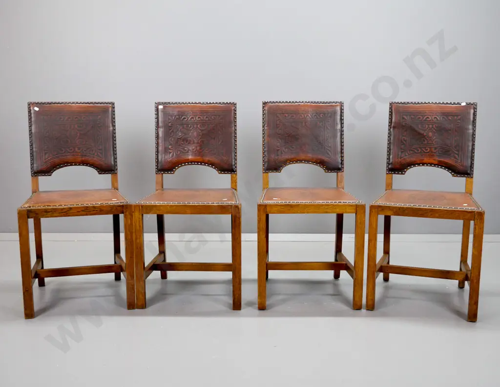 4 vintage oak stretcher base dining chairs with embossed leather seat and back, metal stud edging - some wear to leather Image 1++