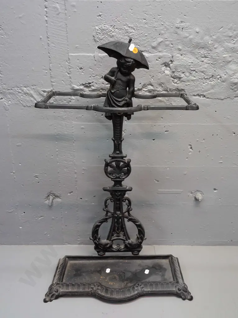 ornate cast metal umbrella stand with dolphins and child with umbrella motifs, 2 piece, both marked "Deponirt" - back Image 1++