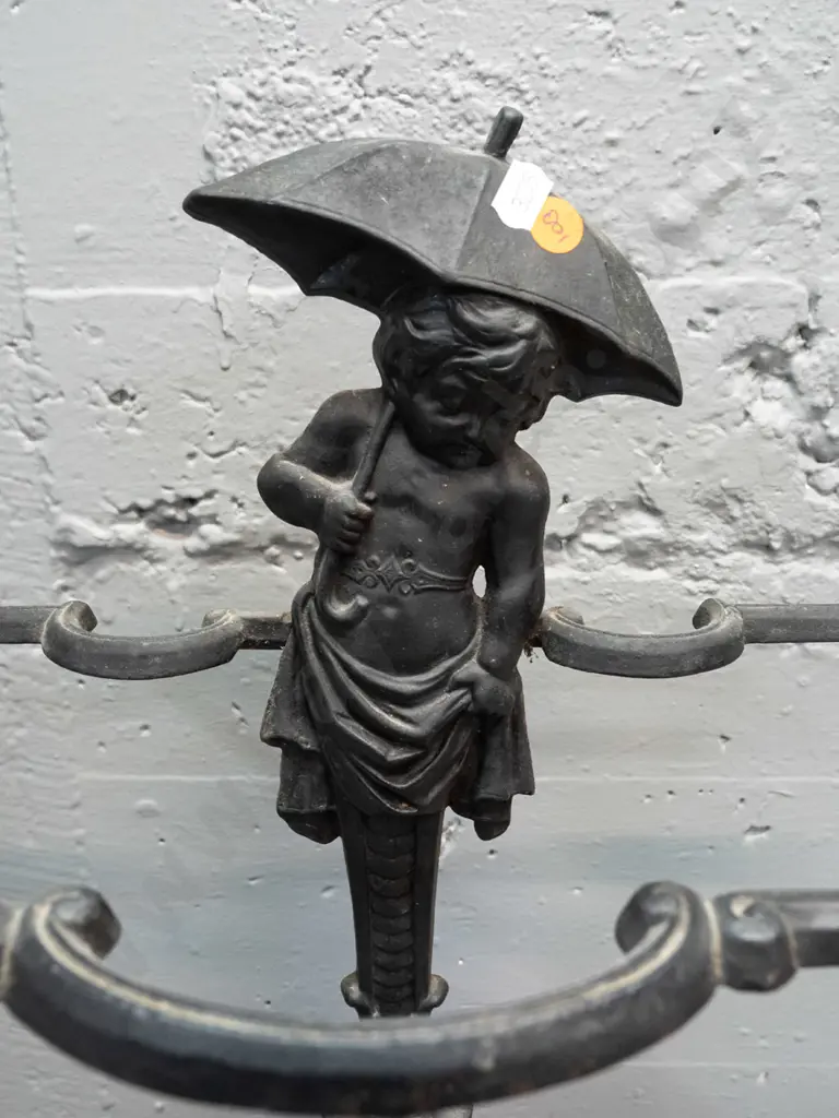 ornate cast metal umbrella stand with dolphins and child with umbrella motifs, 2 piece, both marked "Deponirt" - back Image 1++