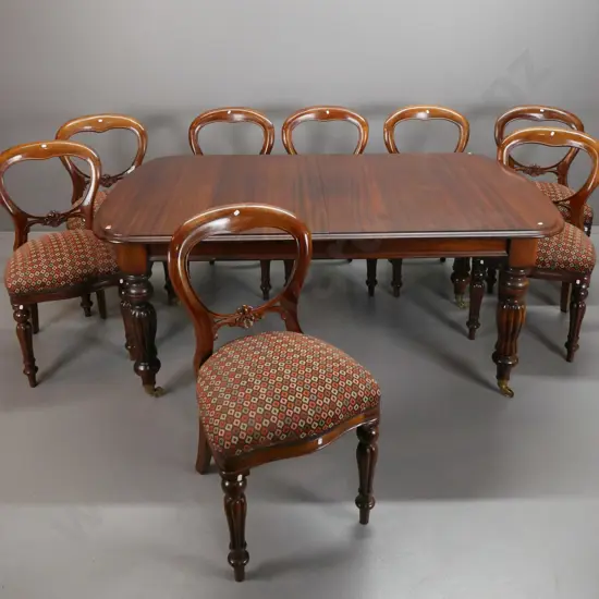 reproduction Victorian style mahogany dining table with turned and fluted legs, large brass cup casters, wind out handle