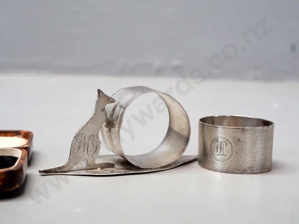 napkin ring with leaf & kangaroo marked Stg Silv, a hallmarked sterling napkin ring and pair of plated sugar tongs Image 1++