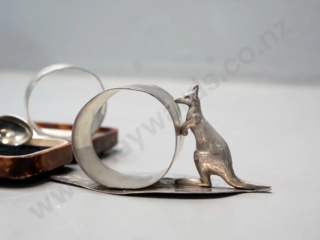 napkin ring with leaf & kangaroo marked Stg Silv, a hallmarked sterling napkin ring and pair of plated sugar tongs Image 1++