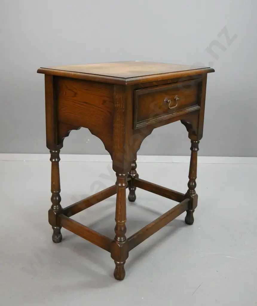oak side table with single drawer, brass swan neck handle, arched sides and front, turned legs on stretcher base H740 Image 1++
