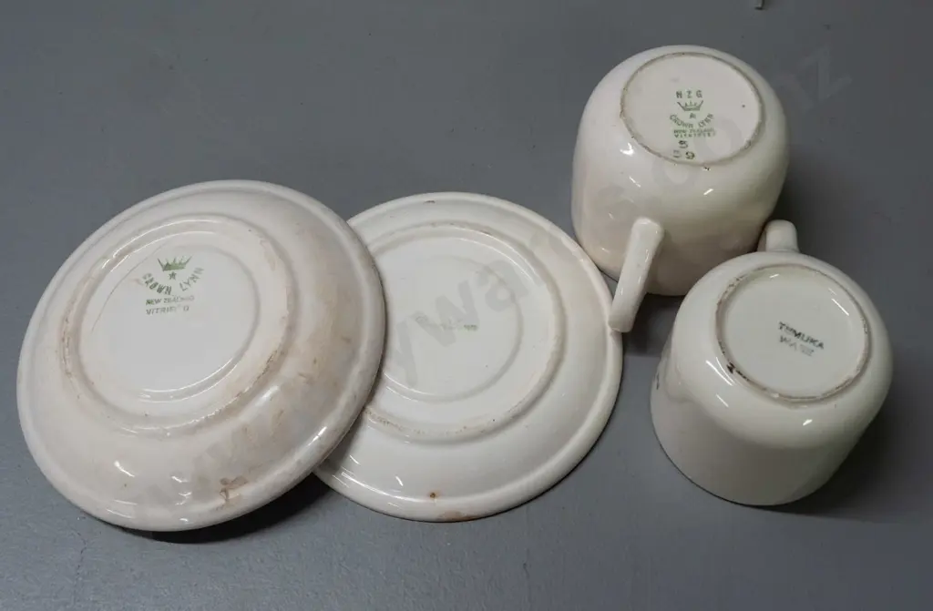 New Zealand Railways logo crockery - Crown Lynn mug and 2 saucers and a Temuka mug - all with staining and chips. Image 1++