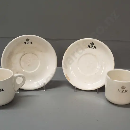 New Zealand Railways logo crockery - Crown Lynn mug and 2 saucers and a Temuka mug - all with staining and chips.