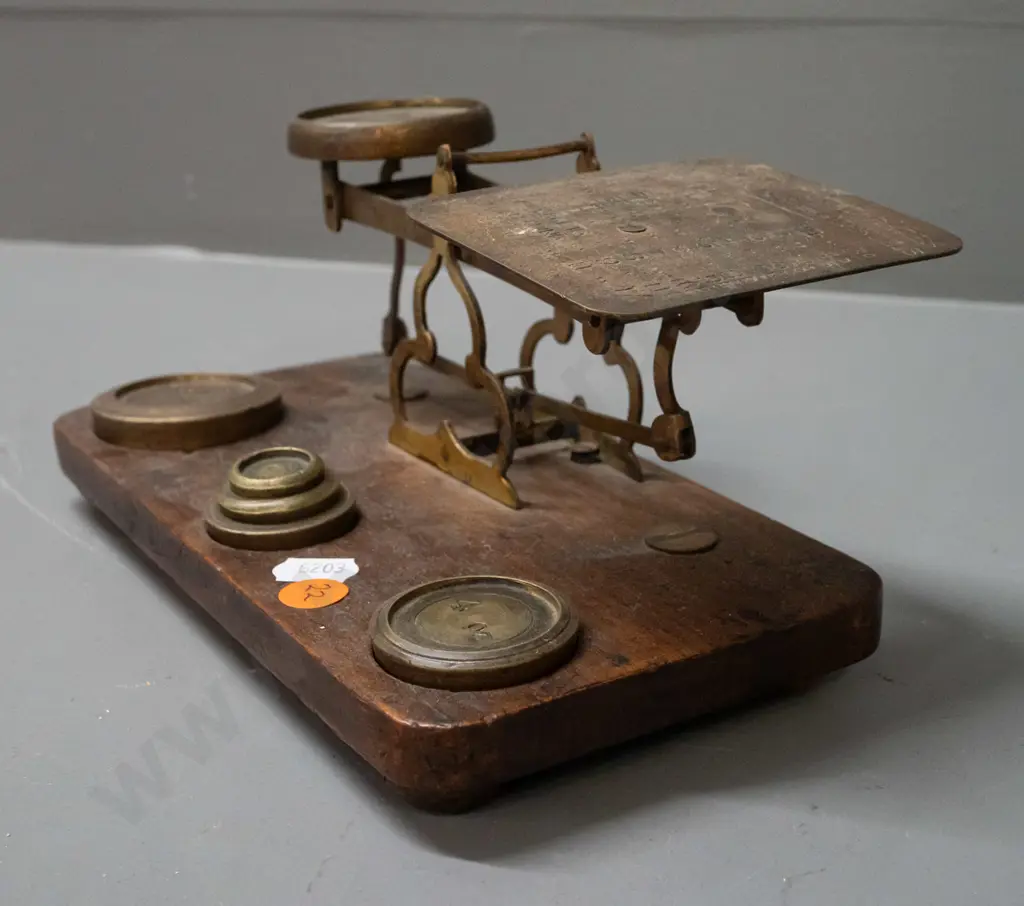 brass postal scales on timber base, with weights, plate is etched with postal rate information, indicator needle is Image 1++
