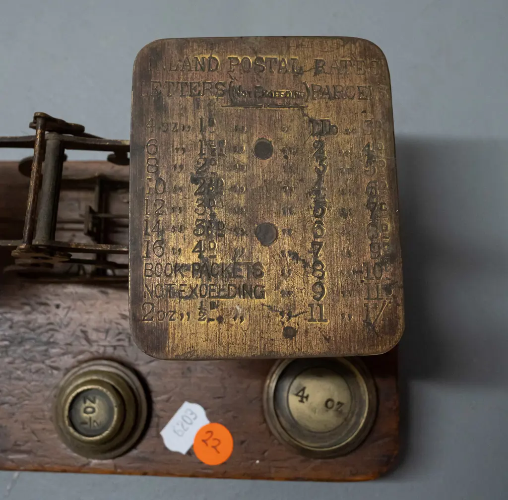 brass postal scales on timber base, with weights, plate is etched with postal rate information, indicator needle is Image 1++