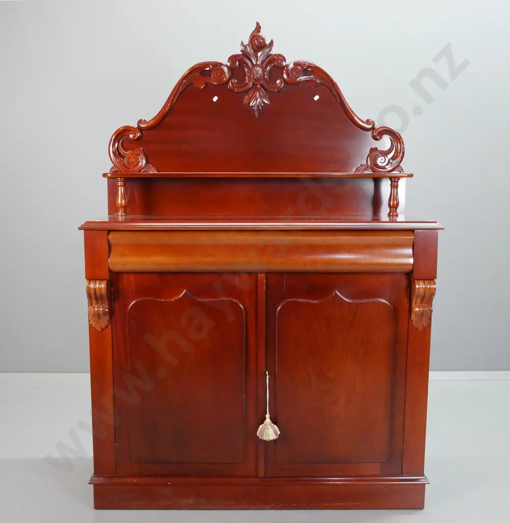reproduction mahogany carved-back chiffonier, shaped top drawer above shield cupboard doors, 2 carved corbels, lock and Image 1++