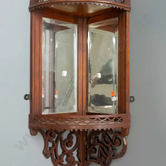 late Victorian walnut small hanging corner display shelf with bevelled edge mirrors, pierced gallery and decoration,