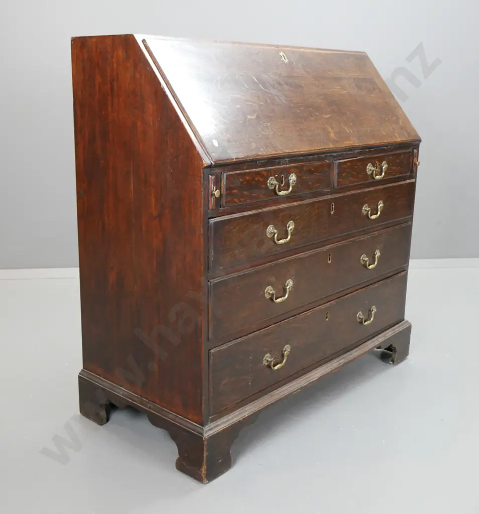 late Georgian oak bureau with 2 small and 3 large drawers, pigeonholes and 7 interior drawers, brass swan-neck handles Image 1++