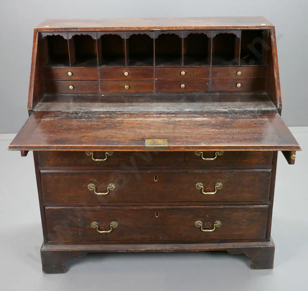 late Georgian oak bureau with 2 small and 3 large drawers, pigeonholes and 7 interior drawers, brass swan-neck handles Image 1++