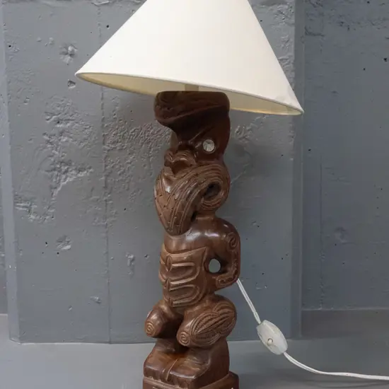 carved timber Maori motif table lamp with inset paua eyes, 1974 presentation plaque, marked Carved in Rotorua NZ on back