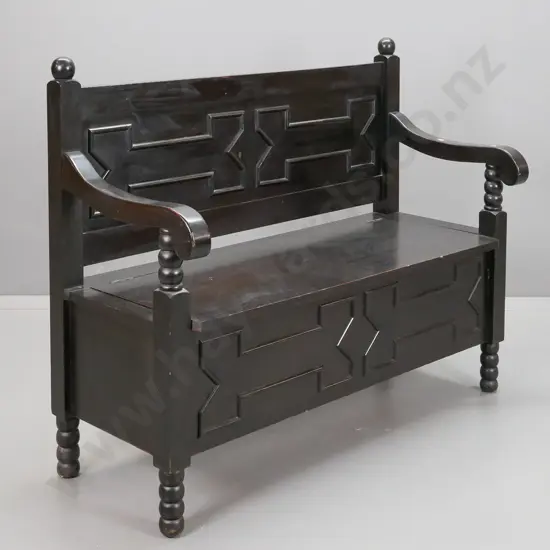 vintage dark stained Jacobean style settle w/ panelled back and lift-up seat, sweeping arms, bobbin turned supports and