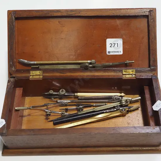 wooden lidded box with various compasses and protractors