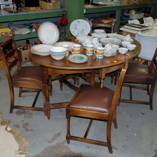 solid oak gate leg extending dining table with 5 brown vinyl ladder back chairs 
