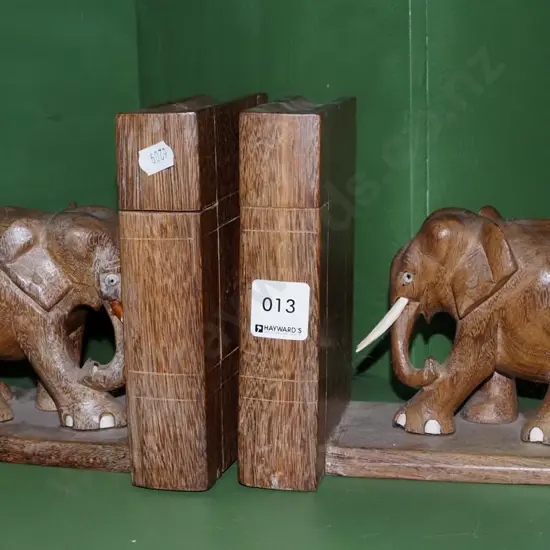 pair of carved wooden elephant bookends with secret compartments