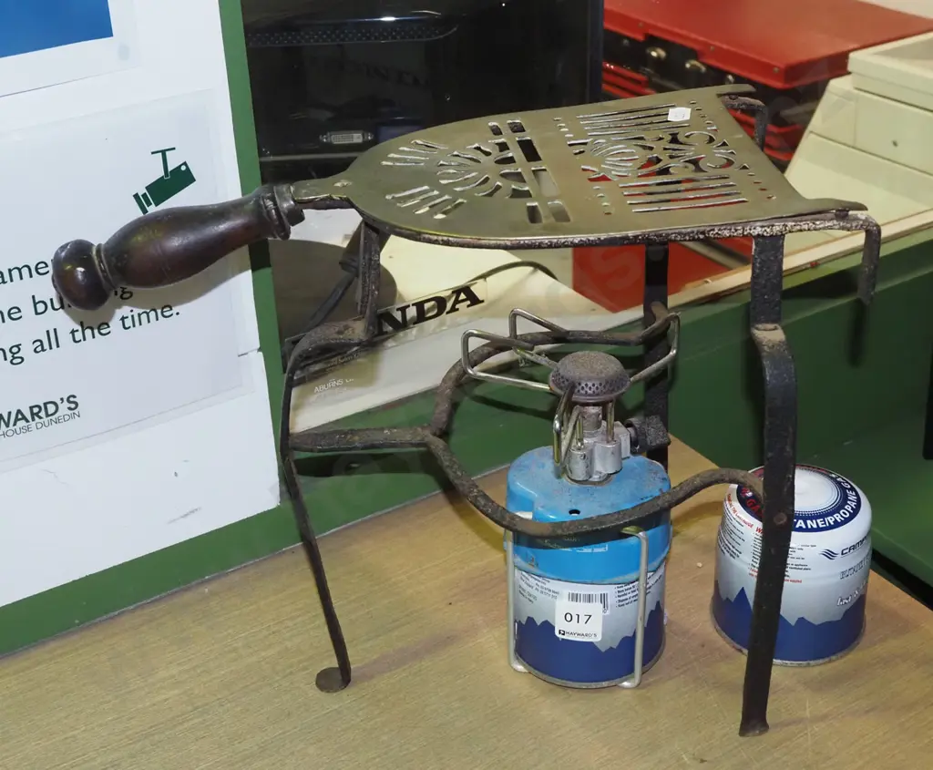 camp stove with additional gas canister, wooden handled brass trivet on stand Image 1++