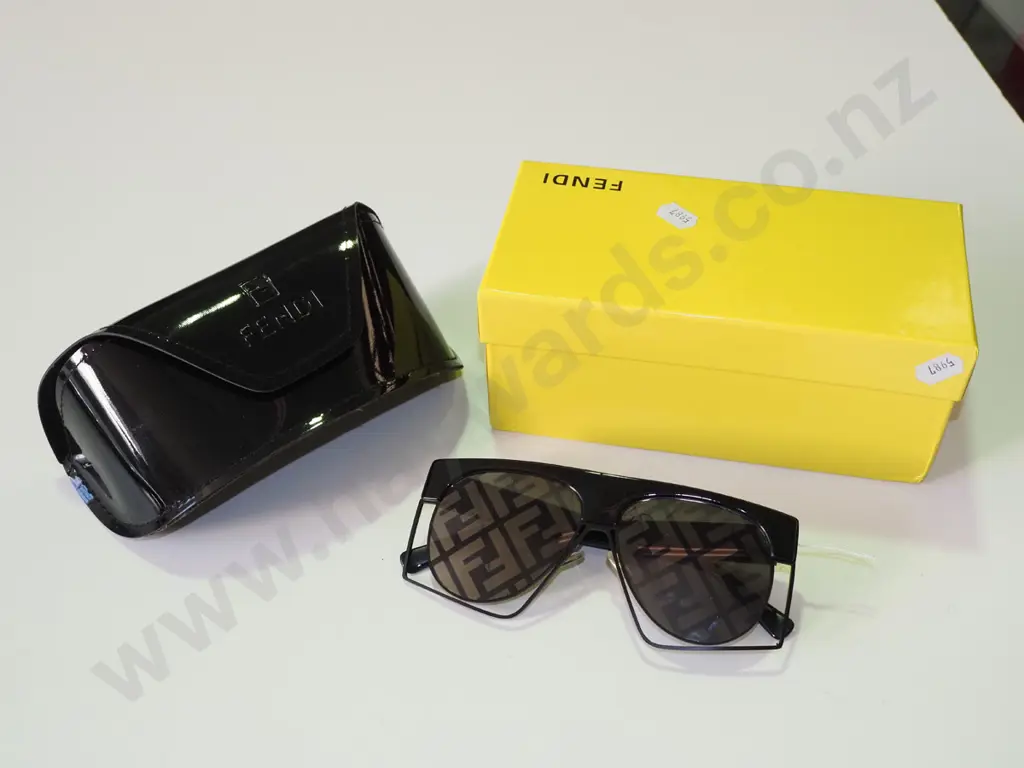 pair of novelty sunglasses in yellow box and case Image 1++
