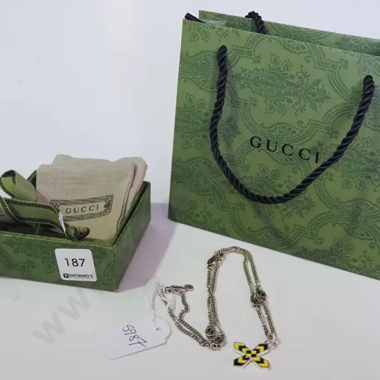 black and yellow cross pendant