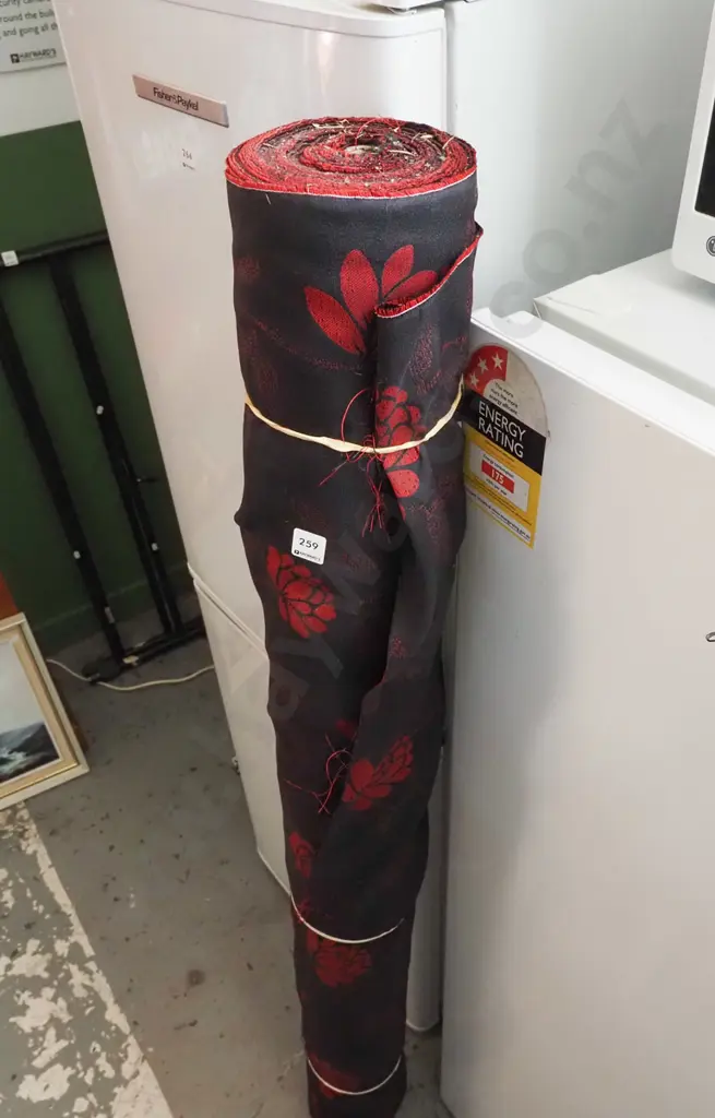 roll of black and red floral fabric Image 1++
