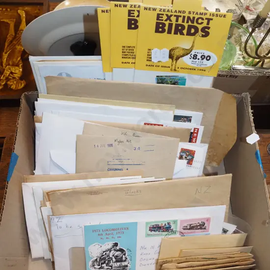 box of stamps and envelopes