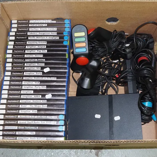box; playstation 2 with controllers and games