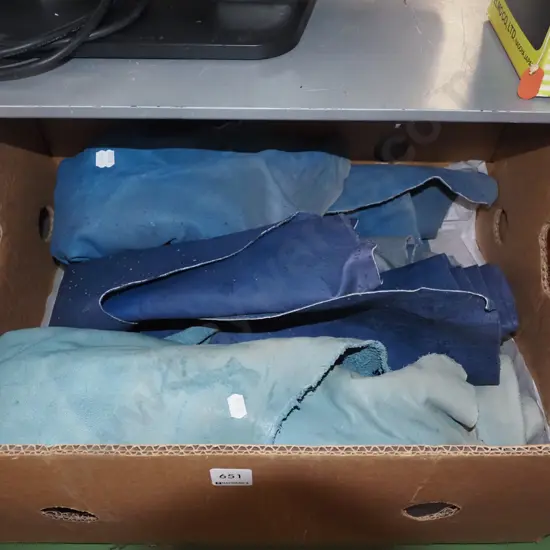 box of blue leather pieces