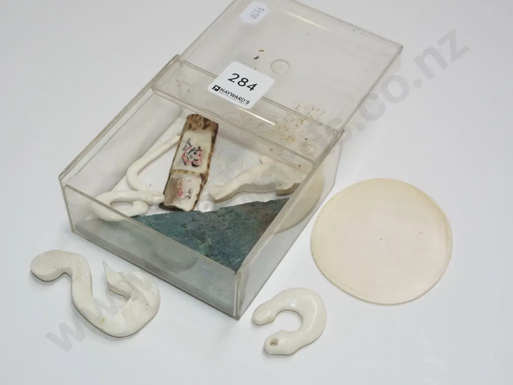 plastic contianer of partially finished bone hooks, piece of jade etc Image 1++