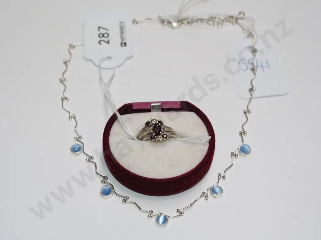 trinity ring with ruby coloured stones (2 stones missing) & a silver necklace with blue coloured stones Image 1++