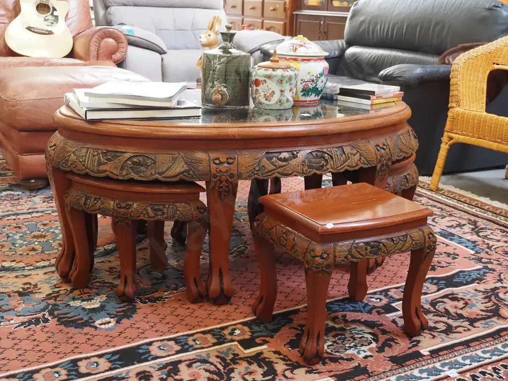 heavily carved Asian occasional  table with 6 pull out stools and oval glass top H-510 W-1200 D-720 Image 1++