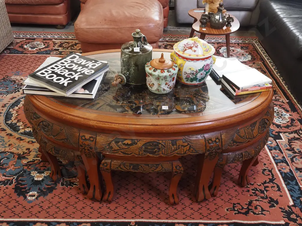 heavily carved Asian occasional  table with 6 pull out stools and oval glass top H-510 W-1200 D-720 Image 1++