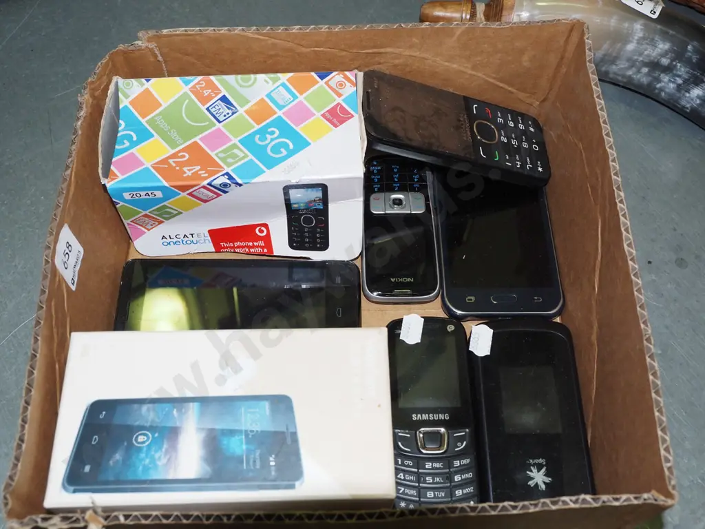 box of early cell phones and accessories Image 1++