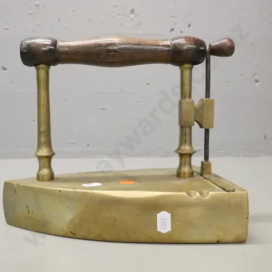 early brass flat coal iron. Turned wooden handle, lift up shutter. Some corrosion to surface H-190 W-220