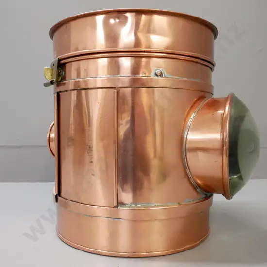 circular copper vintage lantern. Magnifying domed lens on one side, small lens opposite. Brass clasp.