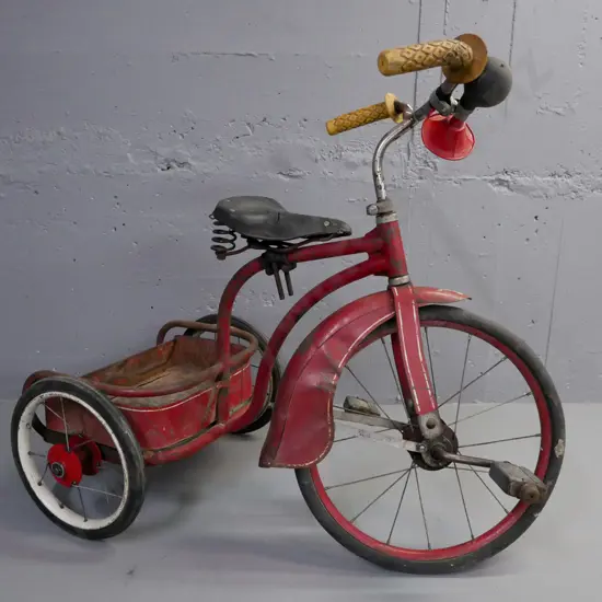 vintage child's spoke-wheel tricycle, red guards and rear carrier, red w/ white pinstriping, rubber tyres.