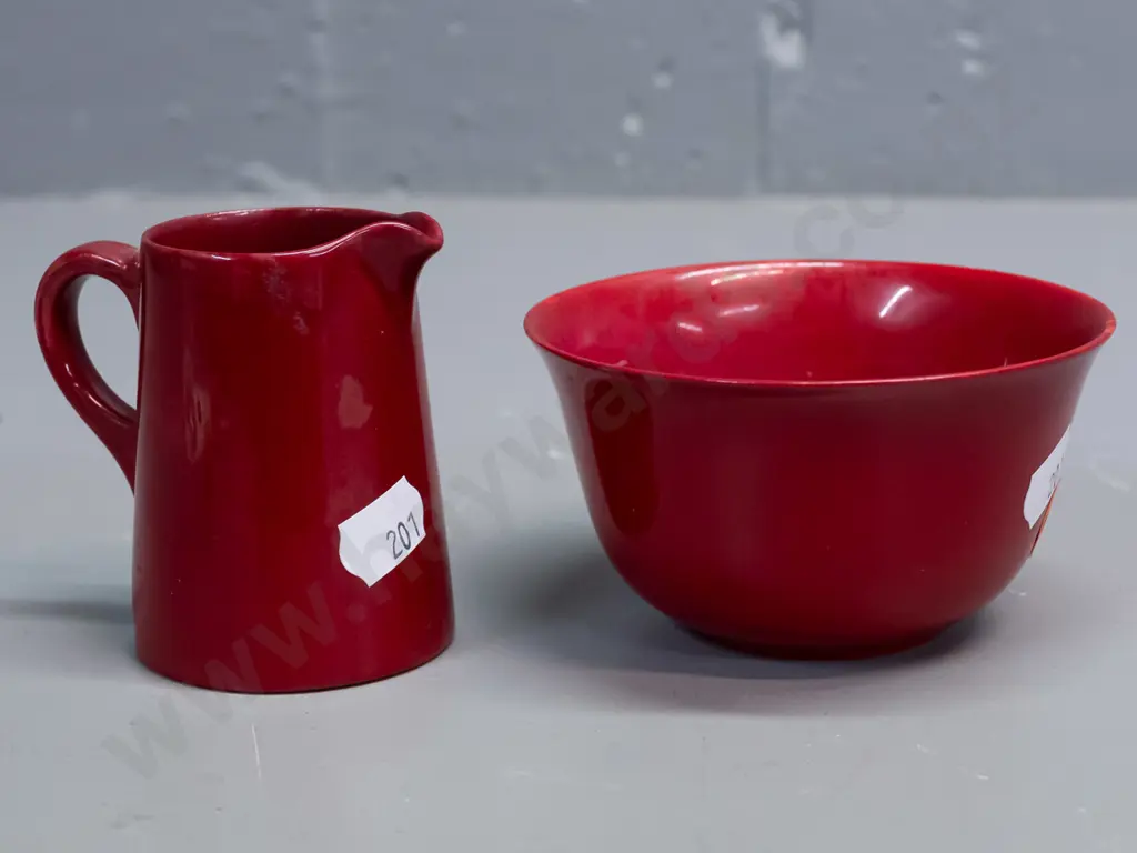 2 small pieces of Royal Doulton Flambe with plain text mark. Bowl has mottled yellow inside. Glaze wear to base of Image 1++