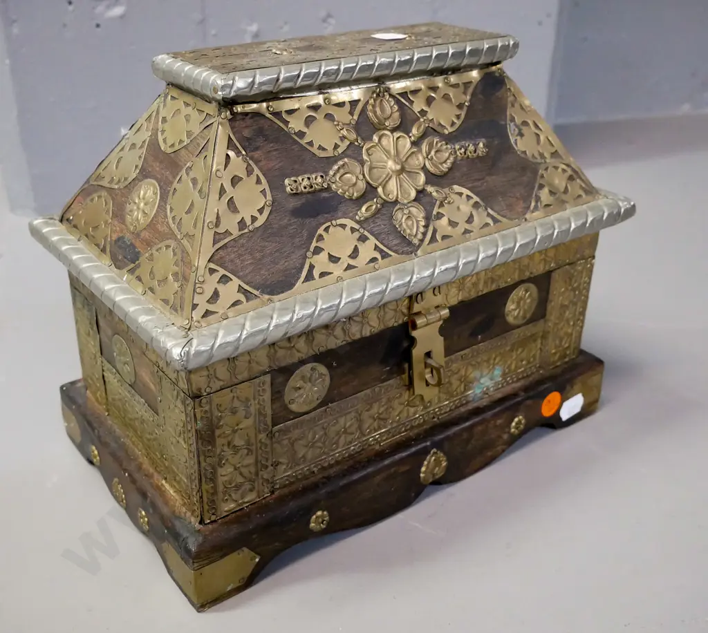 Asian hardwood Sarcophagus-shaped chest with hinged lid, white metal and brass binding, latch & applied decoration. Some Image 1++