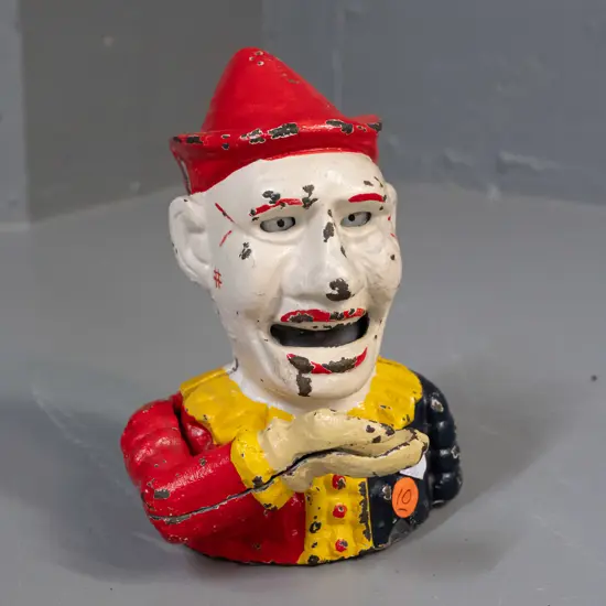 cast metal clown money box with tilting arm mechanism - has paint wear / chipping H-190 W-140