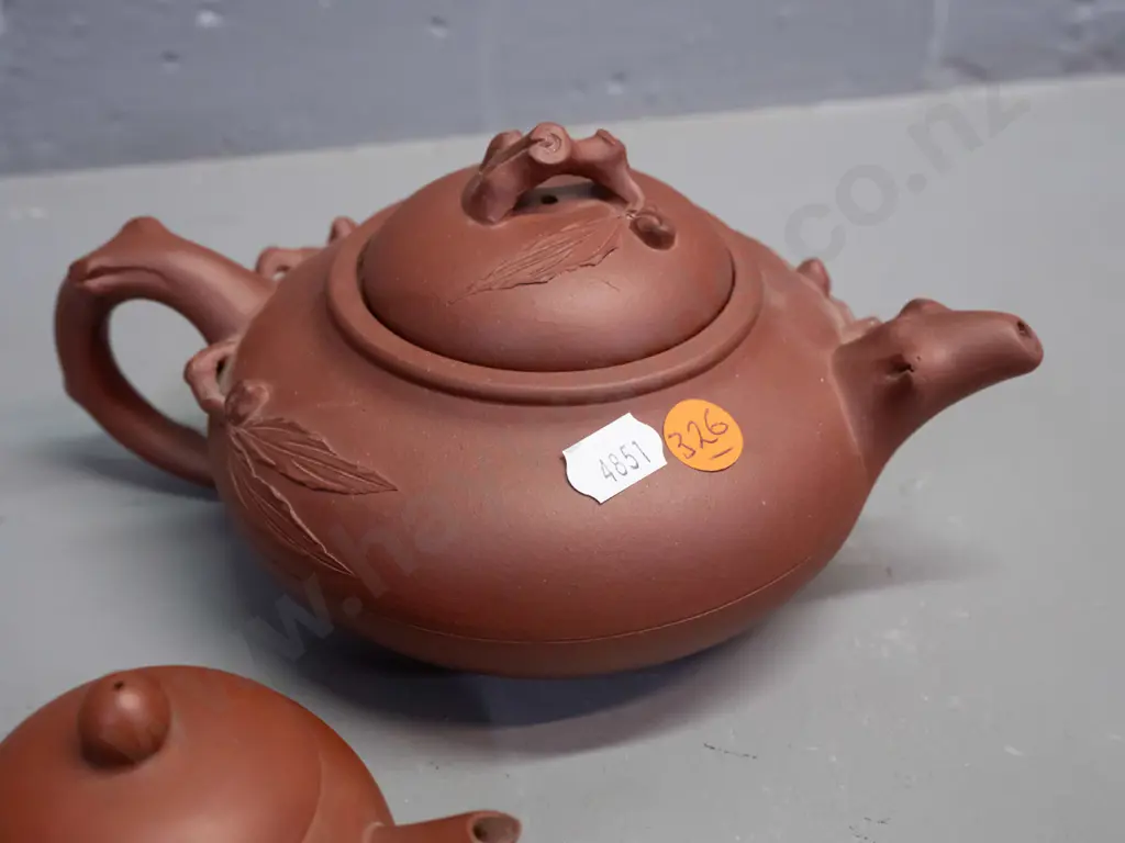 3 Chinese Yixing clay tea pots and 2 small tea bowls, one with leaf & tree forms has small chip in underside of lid, is Image 1++
