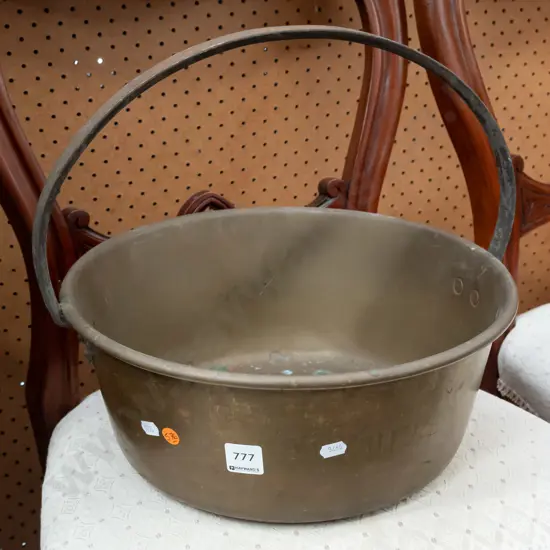 brass jam pan with cast metal handle, some dents and corrosion to bottom, corrosion to handle