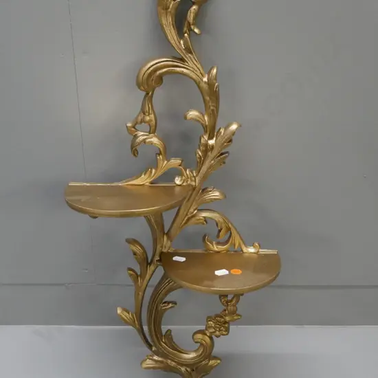 Rococo-style hanging double shelf in gold-painted cast alloy. By Duncraft, Timaru. L-650