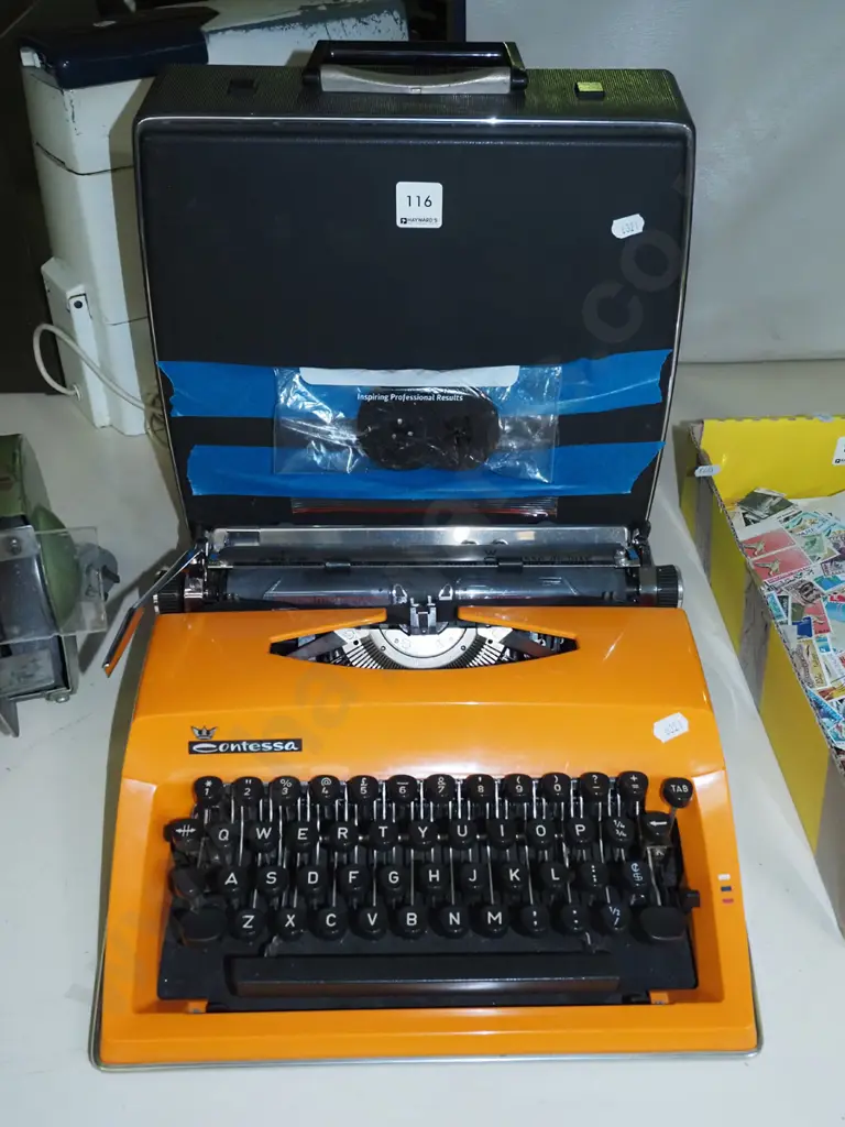 retro orange plastic Contessa typewriter with additional ribbon Image 1++
