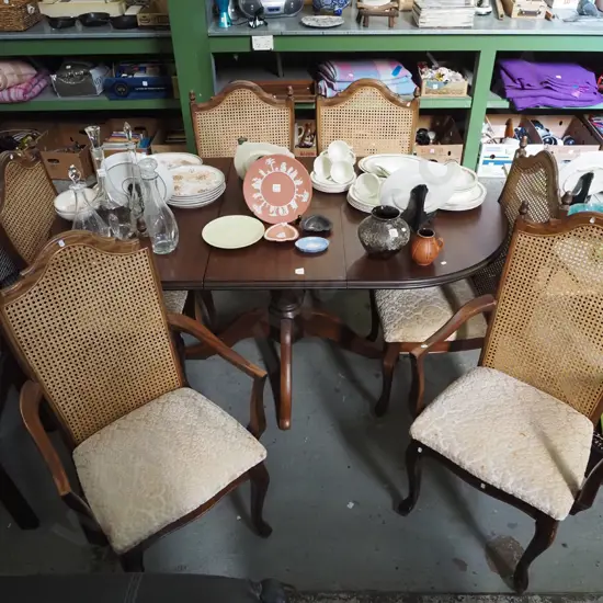pedestal mahogany veneer top extending dining table with 6 matching rattan back chairs