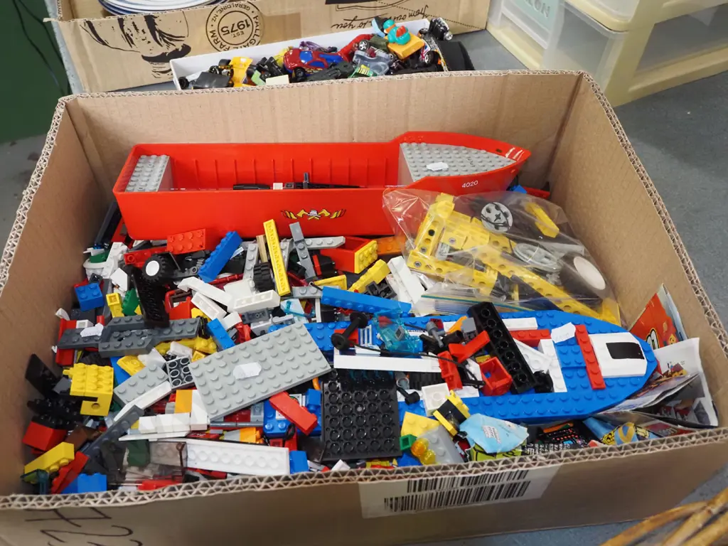 box of Lego pieces Image 1++