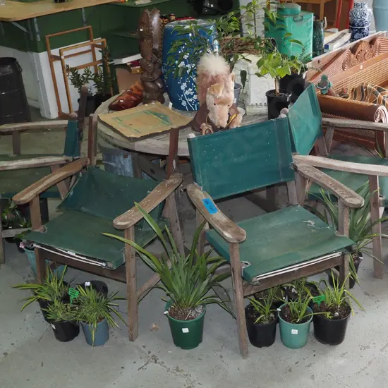 circular hardwood outdoor dining table with 4 canvas chairs -canvas stitching is starting to go