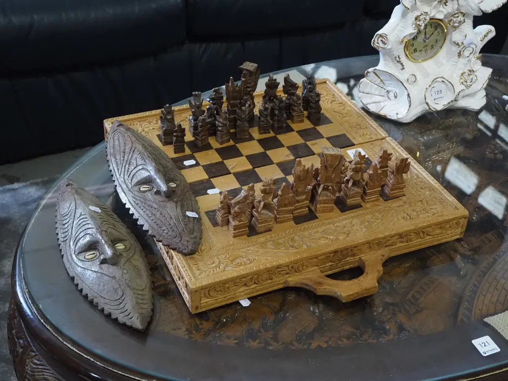 heavily carved Indonesian chess board, 2x ethnic masks Image 1++