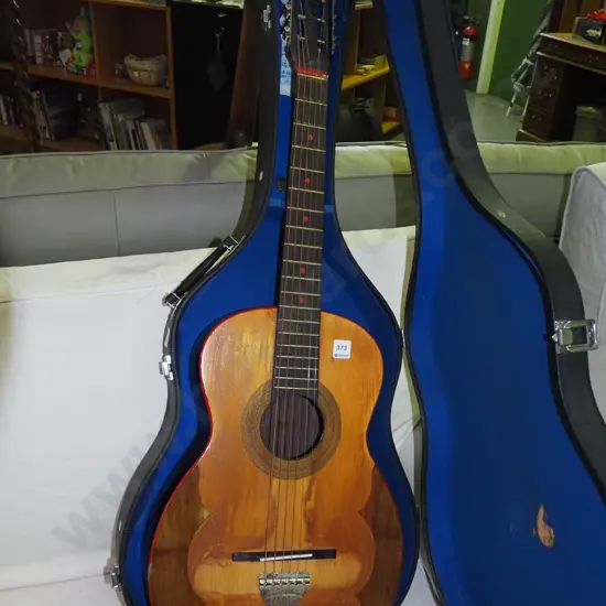 steel string acoustic guitar in hard carry case